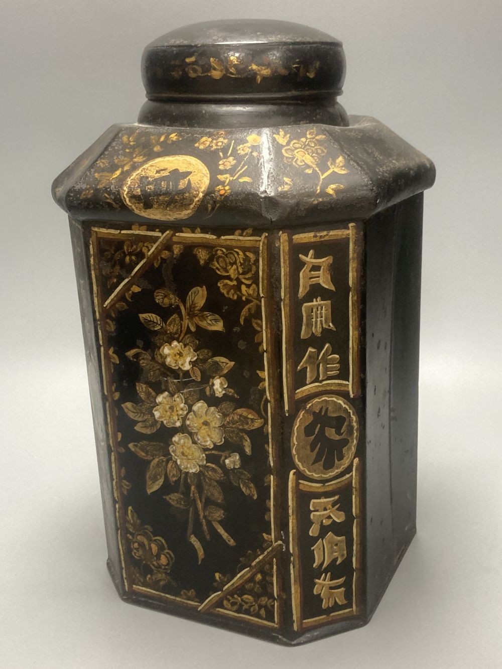 A 19th century toleware octagonal tea canister, J. Newman, Dublin, painted with flowers and Chinese script, 36cm